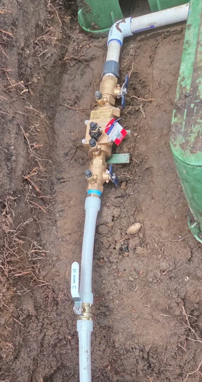 Backflow preventer assembly installed on a water line in a trench