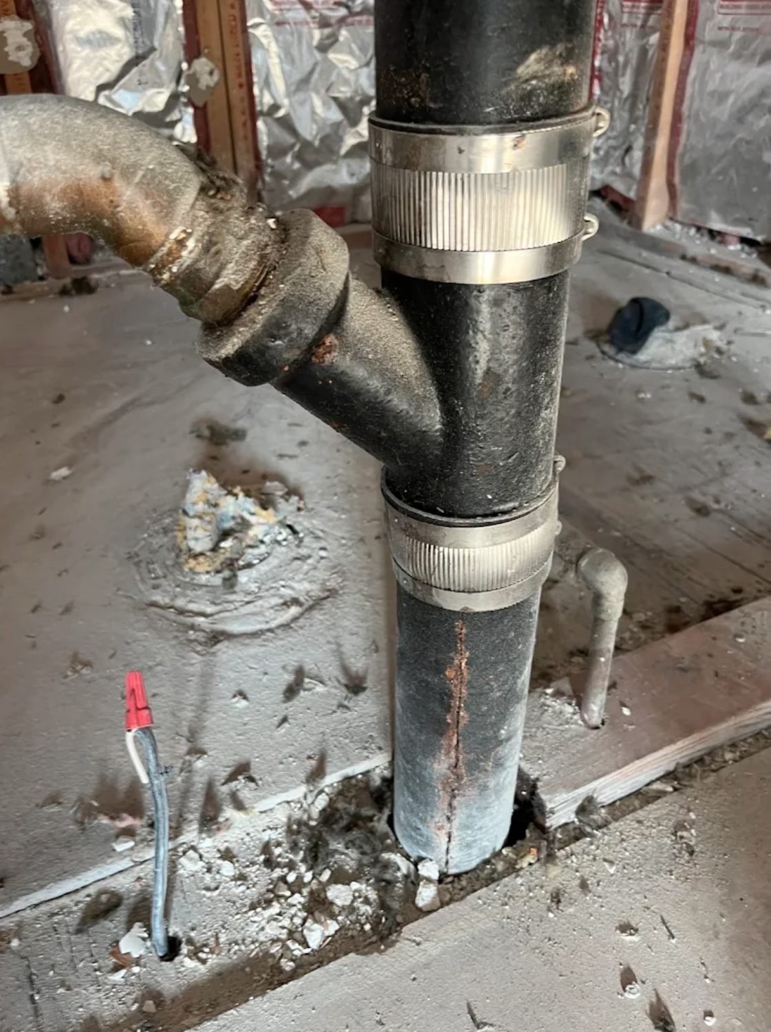 Cast iron stack with a new Y fitting and no hub couplings through a floor