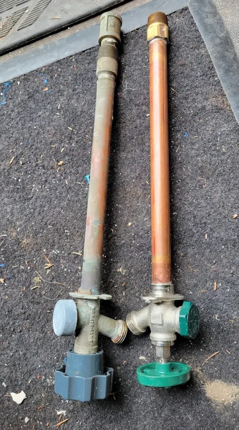 Old corroded hose bib beside its frost free replacement