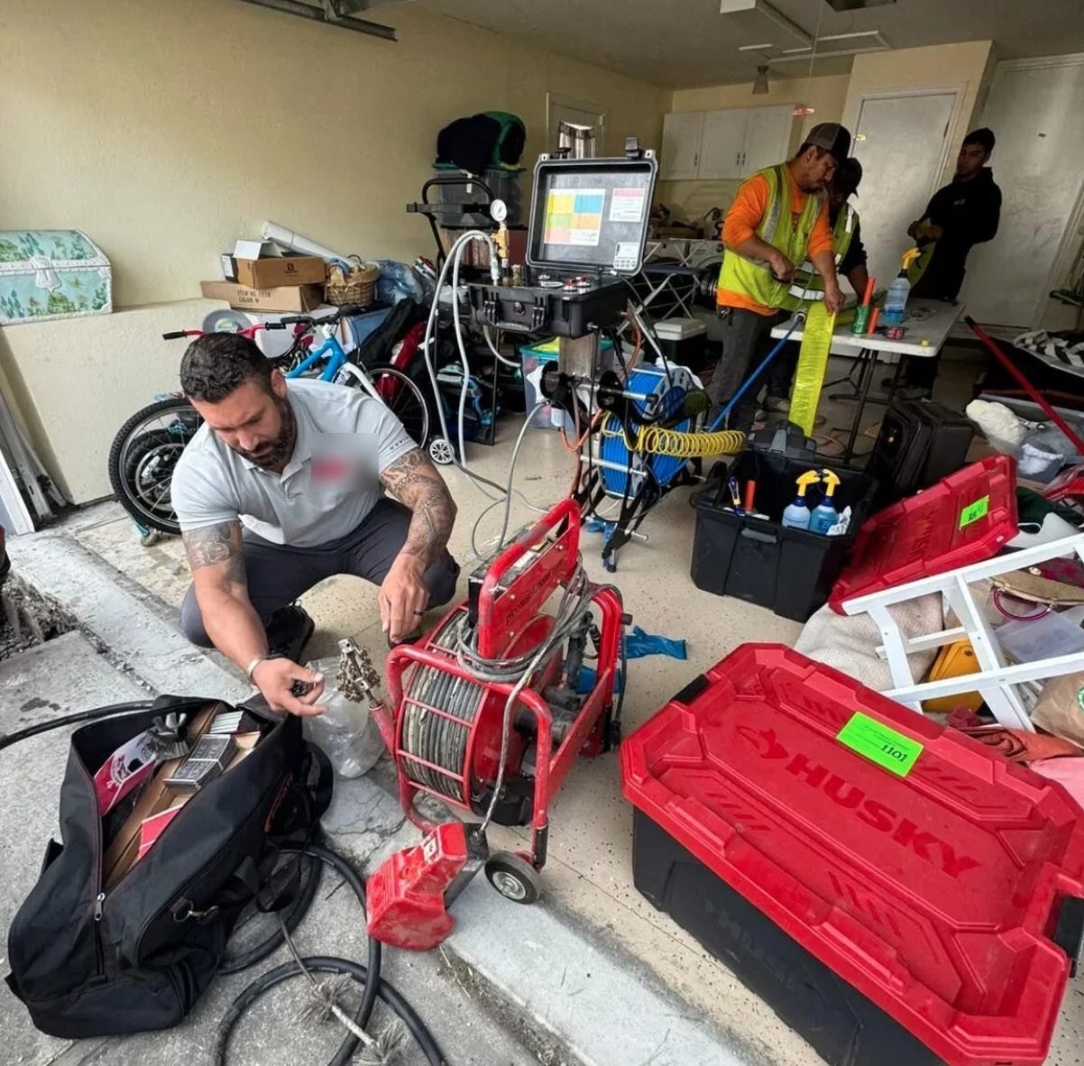 Pipe lining equipment and camera monitor set up inside a garage
