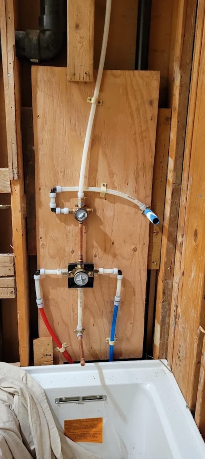 Tub and shower valve rough in mounted on a plywood backer