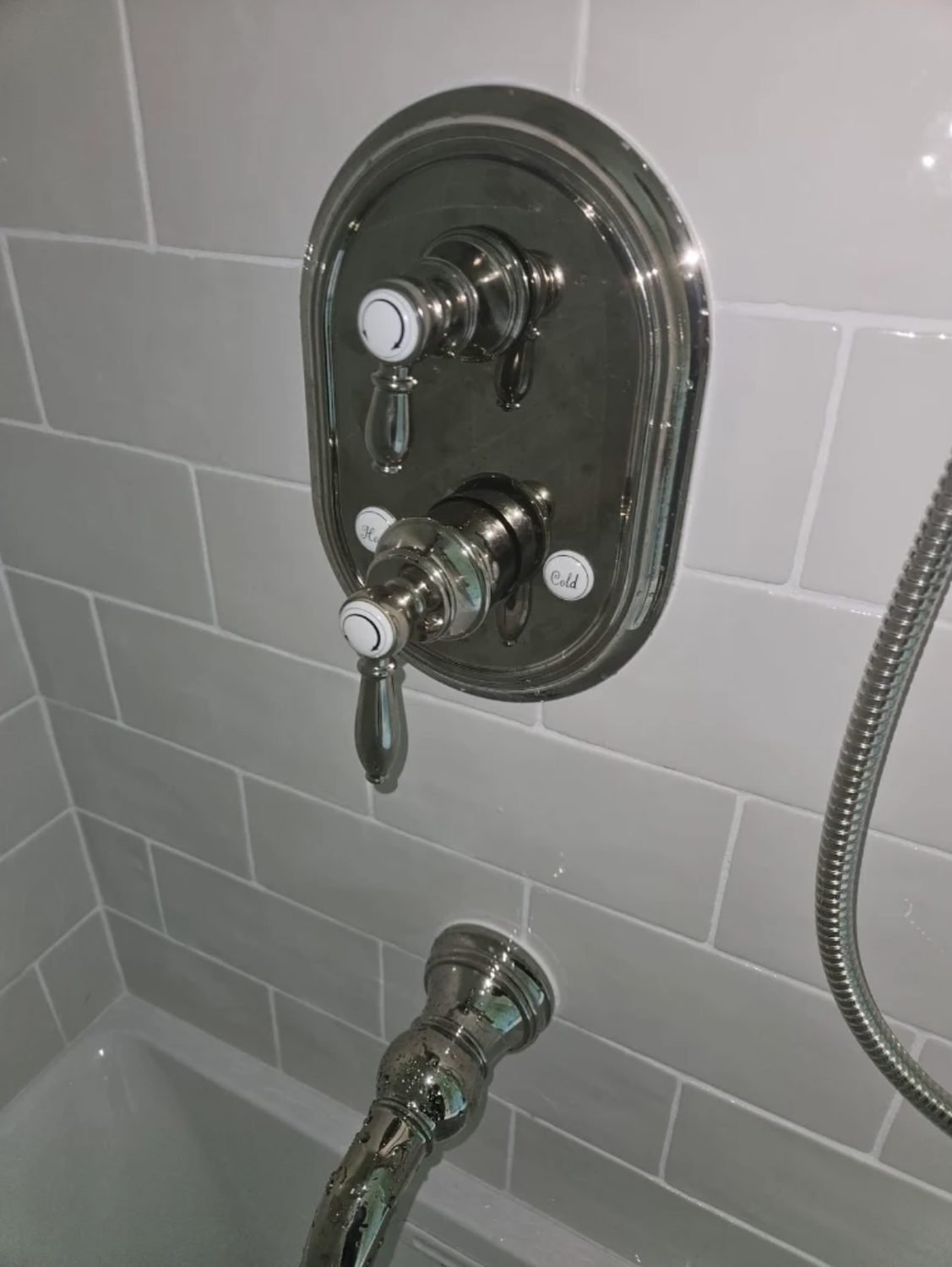 Traditional chrome tub and shower valve trim installed on subway tile