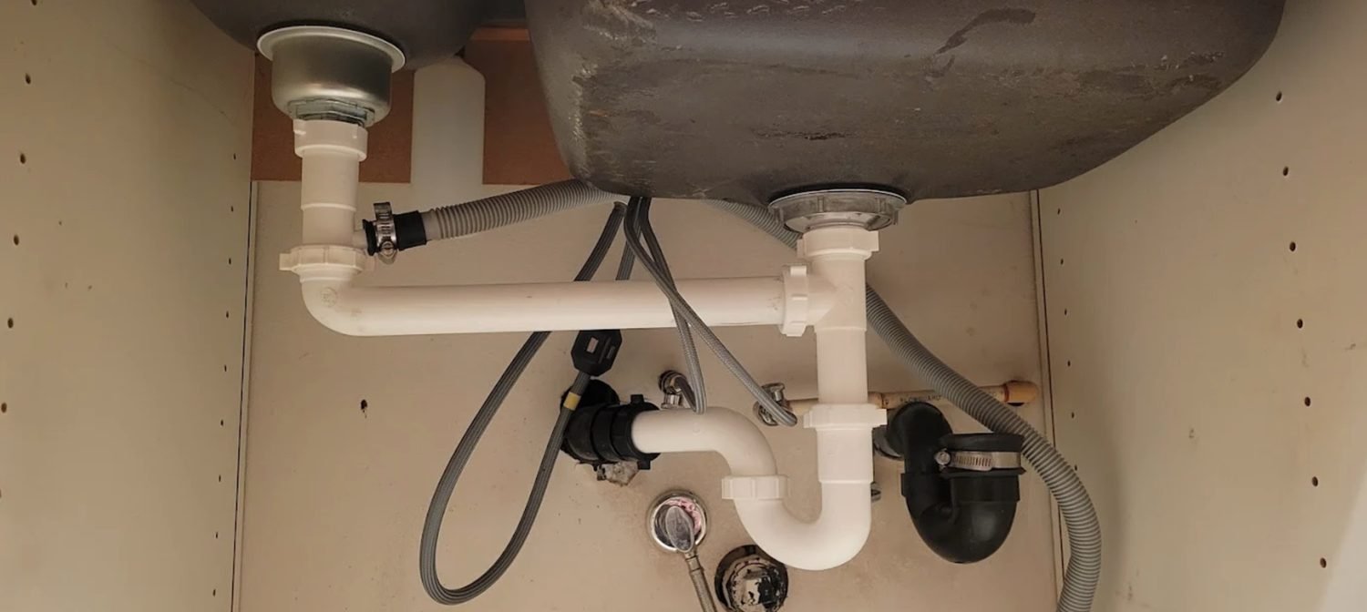 Neat drain trap assembly under a sink after repiping