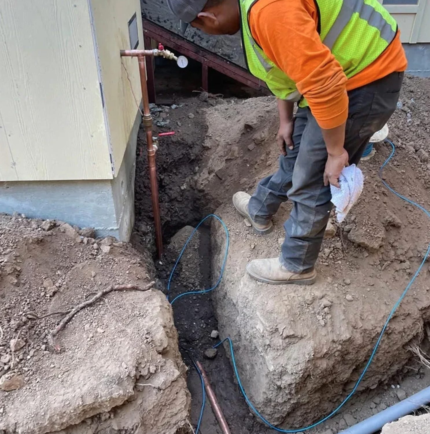 New copper water service being run into the side of a house